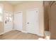 Hallway featuring hardwood floors, white trim, and a variety of doors leading to different parts of the home at 2110 N Talbott St, Indianapolis, IN 46202
