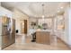Spacious kitchen boasts an island, stainless steel appliances, light wood floors, and stylish white cabinetry at 2110 N Talbott St, Indianapolis, IN 46202