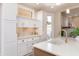 Kitchen featuring white cabinets, gold hardware, light countertops, and stainless steel sink at 2110 N Talbott St, Indianapolis, IN 46202