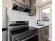 Kitchen boasts stainless steel appliances, a white marble backsplash, and light-colored cabinets at 2110 N Talbott St, Indianapolis, IN 46202