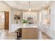 Lovely kitchen with white cabinets, wood island with bar stool seating, and a decorative tile backsplash at 2110 N Talbott St, Indianapolis, IN 46202