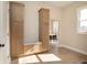 Bright mudroom featuring custom built-in cabinets, hardwood floors, and access to the dining room and natural light at 2110 N Talbott St, Indianapolis, IN 46202