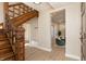 Elegant wooden staircase leads into the home with built in bench and bright living space at 2110 N Talbott St, Indianapolis, IN 46202