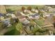 Aerial view of a home with a backyard pool, mature trees, and lush green lawns in a suburban neighborhood at 21360 Oakview Dr, Noblesville, IN 46062