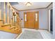 Inviting entryway featuring a wood front door, staircase, and tiled floor, offering a warm welcome at 21360 Oakview Dr, Noblesville, IN 46062