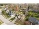 Aerial view of a suburban home featuring a pool, well-manicured lawn, mature trees, and a two-car garage at 21360 Oakview Dr, Noblesville, IN 46062
