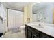 Bathroom with a black vanity, a large mirror, and white shower curtain at 21360 Oakview Dr, Noblesville, IN 46062