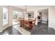 Dining area with wood table, natural light, and view into the living room at 21360 Oakview Dr, Noblesville, IN 46062
