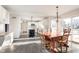 Sunlit open kitchen with white cabinets, stainless appliances, large island, and adjacent dining area at 21360 Oakview Dr, Noblesville, IN 46062