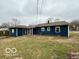 Back exterior view of home showing modest yard and blue siding at 3039 N Campbell Ave, Indianapolis, IN 46218