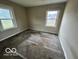 A bedroom with neutral walls, carpeted floor, and two windows providing natural light at 3039 N Campbell Ave, Indianapolis, IN 46218