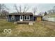 Single story home featuring a modest front porch and blue siding at 3039 N Campbell Ave, Indianapolis, IN 46218