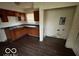 Small kitchen area with wooden cabinets and vinyl flooring at 3039 N Campbell Ave, Indianapolis, IN 46218