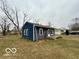 Exterior view of the home featuring blue siding and a modest yard at 3039 N Campbell Ave, Indianapolis, IN 46218