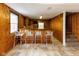 Basement wet bar featuring paneled walls, barstool seating, and mini-kitchenette at 3233 E 48Th St, Indianapolis, IN 46205