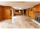 Large basement area featuring paneled walls, tile flooring, fireplace and a bar area at 3233 E 48Th St, Indianapolis, IN 46205