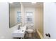 Cozy bathroom with tiled walls, modern sink, toilet, and window at 3233 E 48Th St, Indianapolis, IN 46205