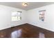 Bedroom with hardwood floors and natural light from two windows overlooking the yard at 3233 E 48Th St, Indianapolis, IN 46205