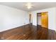 Bright bedroom features hardwood floors, ceiling fan, and closet with sliding doors at 3233 E 48Th St, Indianapolis, IN 46205