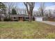 Charming one-story brick home featuring a well-manicured lawn and attached two-car garage at 3233 E 48Th St, Indianapolis, IN 46205