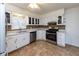 Well-lit kitchen boasts stainless steel appliances, mosaic backsplash, and ample cabinet space at 3233 E 48Th St, Indianapolis, IN 46205