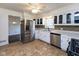 Modern kitchen with stainless steel appliances, white cabinetry, and a stylish tile backsplash at 3233 E 48Th St, Indianapolis, IN 46205
