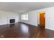 Bright living room featuring a fireplace, hardwood floors, and a large window for natural light at 3233 E 48Th St, Indianapolis, IN 46205