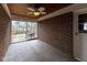 Enclosed sunroom with brick walls, tiled floor, wood paneled ceiling and ceiling fan at 3233 E 48Th St, Indianapolis, IN 46205
