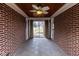 Enclosed sunroom with brick walls, tile flooring, and a wood paneled ceiling with ceiling fan at 3233 E 48Th St, Indianapolis, IN 46205