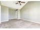 A bright bedroom with a ceiling fan, neutral walls, and soft carpet at 3841 Constitution Dr, Carmel, IN 46032