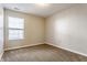 Clean, neutral-toned bedroom with plush carpeting and a bright window at 3841 Constitution Dr, Carmel, IN 46032