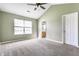 Spacious bedroom with neutral walls, plush carpeting, ceiling fan, and an en-suite bathroom at 3841 Constitution Dr, Carmel, IN 46032