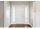 Bright entryway features wood flooring and a white front door with sidelights at 3841 Constitution Dr, Carmel, IN 46032