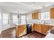 Bright kitchen with wood cabinets, black dishwasher, and a sink under a large window at 3841 Constitution Dr, Carmel, IN 46032