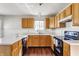 Well-lit kitchen featuring white countertops, oak cabinets, and modern appliances at 3841 Constitution Dr, Carmel, IN 46032