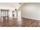 Spacious living room with vaulted ceiling, wood floors, chandelier, and sliding door to the backyard at 3841 Constitution Dr, Carmel, IN 46032