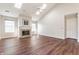 Bright living room featuring vaulted ceiling, skylights, wood floors, and fireplace at 3841 Constitution Dr, Carmel, IN 46032