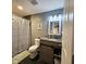 Bathroom with black tile floor, shower/tub combination, and granite countertop sink at 422 Johnson Ave, Franklin, IN 46131
