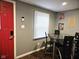 Dining area featuring a modern glass-top table with seating, wood flooring, and gray walls at 422 Johnson Ave, Franklin, IN 46131