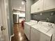 Laundry room with washer and dryer, storage cabinets, and access to the kitchen at 422 Johnson Ave, Franklin, IN 46131