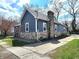 Exterior view showcases stone accents, a brick chimney, fresh landscaping, and a paved driveway at 422 Johnson Ave, Franklin, IN 46131