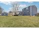 A spacious backyard featuring a deck, storage shed and green grass at 455 Meadowview Ln, Greenwood, IN 46142