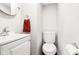 Cozy bathroom with tiled walls, toilet, sink, mirror, and towel rack at 455 Meadowview Ln, Greenwood, IN 46142