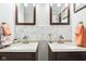 Bathroom vanity with double sinks, stylish mirrors, and decorative backsplash at 455 Meadowview Ln, Greenwood, IN 46142