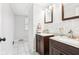 Well-lit bathroom with double vanity, modern fixtures, and tiled floors at 455 Meadowview Ln, Greenwood, IN 46142
