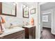 Dual sink bathroom vanity with modern fixtures, decorative backsplash, and ample lighting at 455 Meadowview Ln, Greenwood, IN 46142