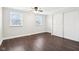 Spacious bedroom with hardwood floors, two windows, and a large closet at 455 Meadowview Ln, Greenwood, IN 46142