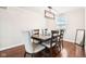 Dining room features a modern chandelier, wood table with six chairs, and hardwood floors at 455 Meadowview Ln, Greenwood, IN 46142