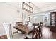 Open floor plan with dining room featuring a modern chandelier, wood table with six chairs at 455 Meadowview Ln, Greenwood, IN 46142