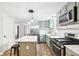 Charming kitchen featuring stainless steel appliances, white countertops, gray cabinets, and island with seating at 455 Meadowview Ln, Greenwood, IN 46142